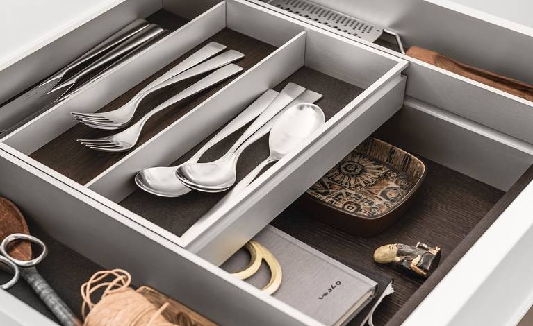 A bi-level drawer elegantly doubles storage space in SieMatic kitchen drawers