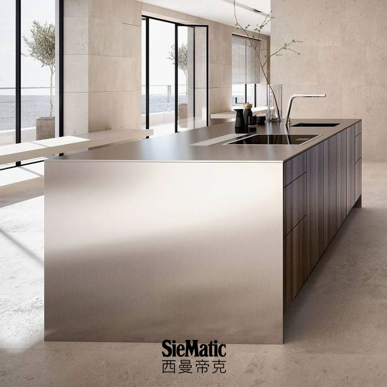 SieMatic Pure SE kitchen island in smoked oak veneer with countertop and side panels that appear 1 cm thick in stainless steel